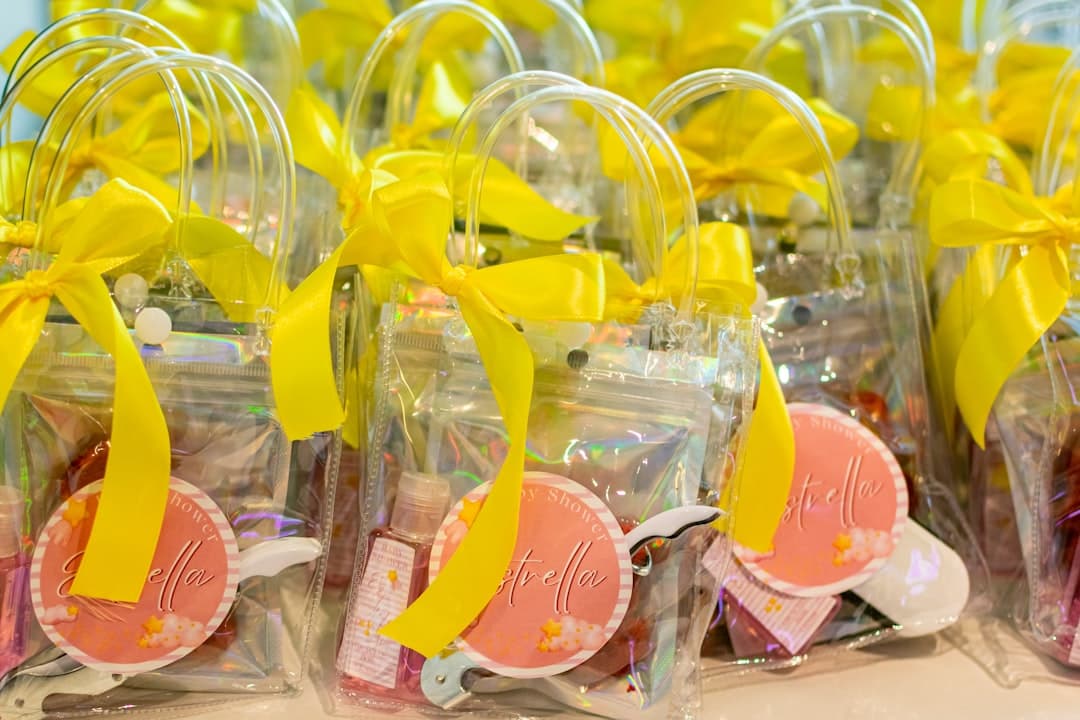 Clear gift bags with yellow ribbons and pink tags
