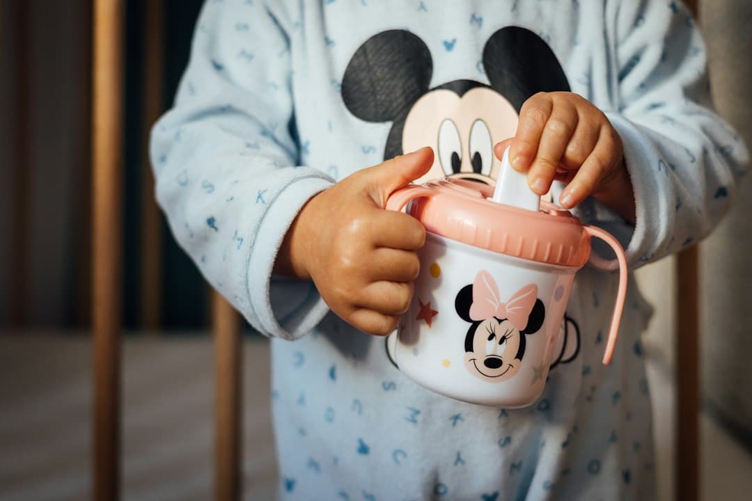 a child holding a cup