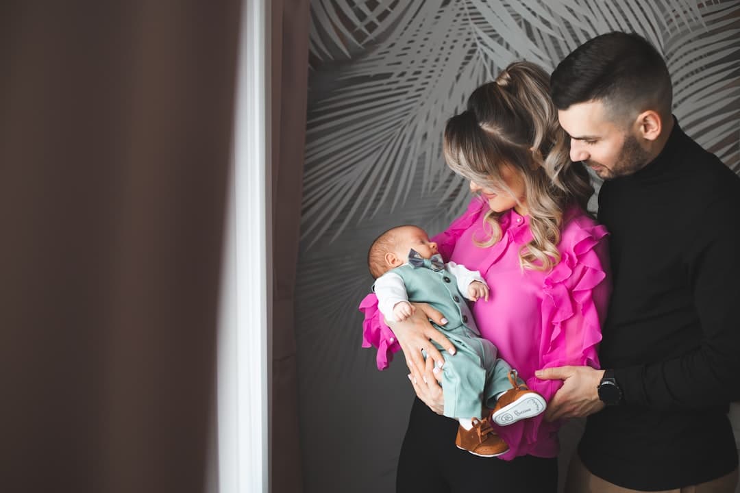 Parents holding their newborn baby together