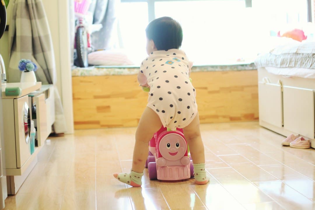 a toddler playing with a toy on the floor