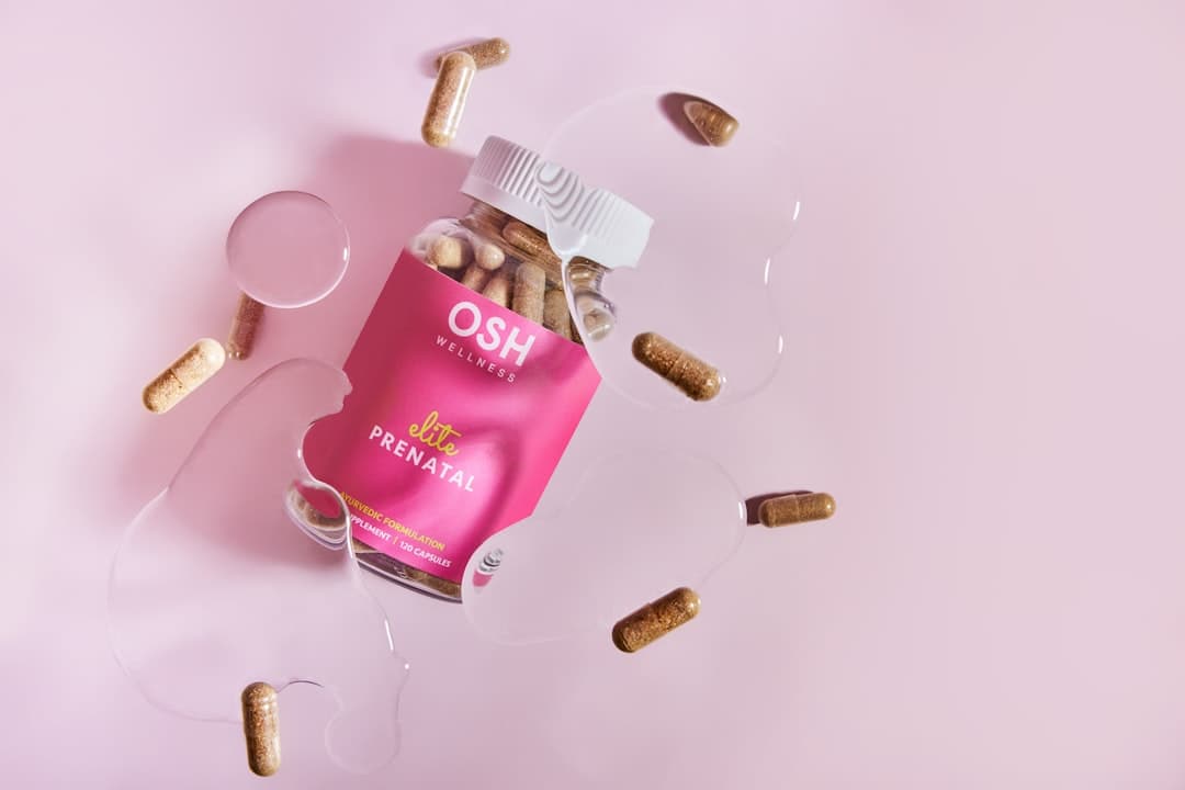 A pink box of pills and a glass of water